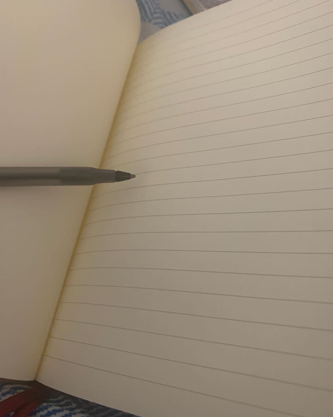 A notebook with a pen resting on it
